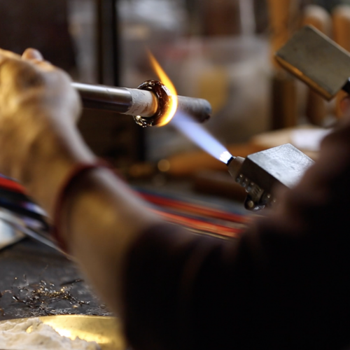 a glass bead being made in the flame